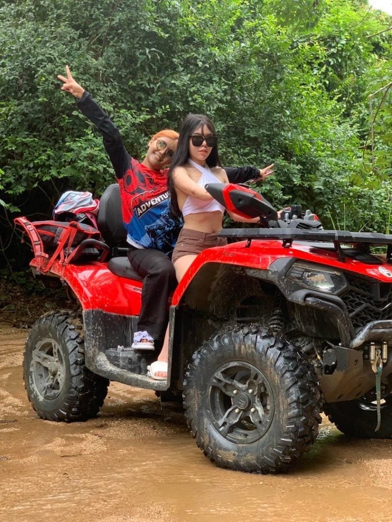 Thai girls riding a red ATV in Thailand