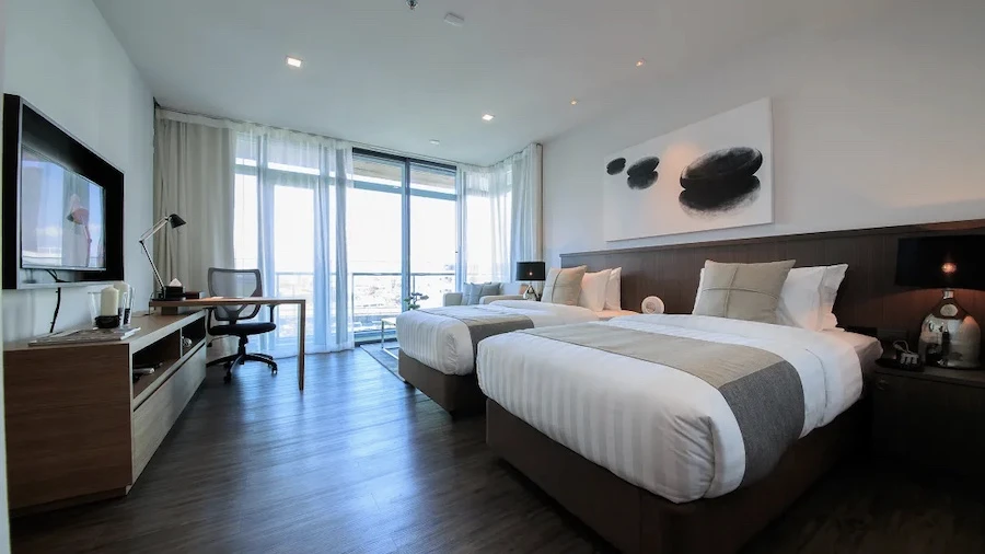 view of a room at civic horizon hotel in bangkok with two queen size beds and a zen and simple decoration