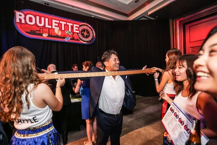 girls holding tickets in front of an executive at a corporate event in Bangkok
