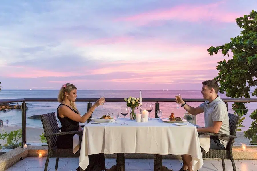 couple dining next to the beach at an adults only resort in Thailand