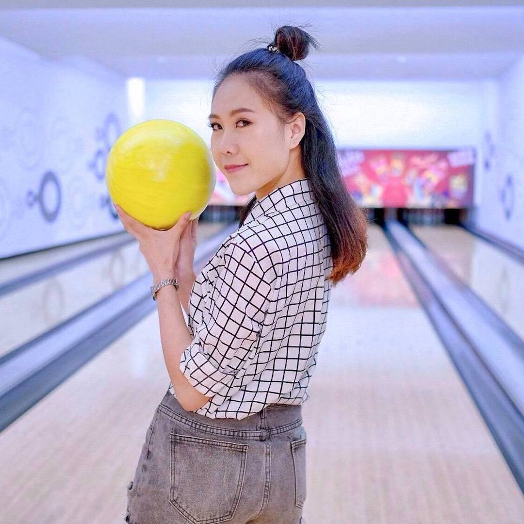 cute Thai girl holding a bowling ball