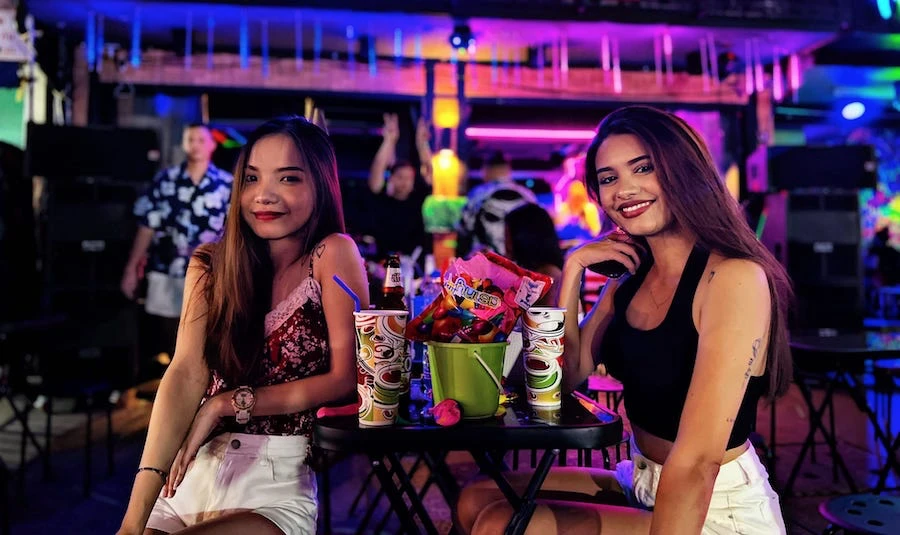 two cute Thai girls drinking buckets of booze at Sup Dude bar in Khaosan road in Bangkok