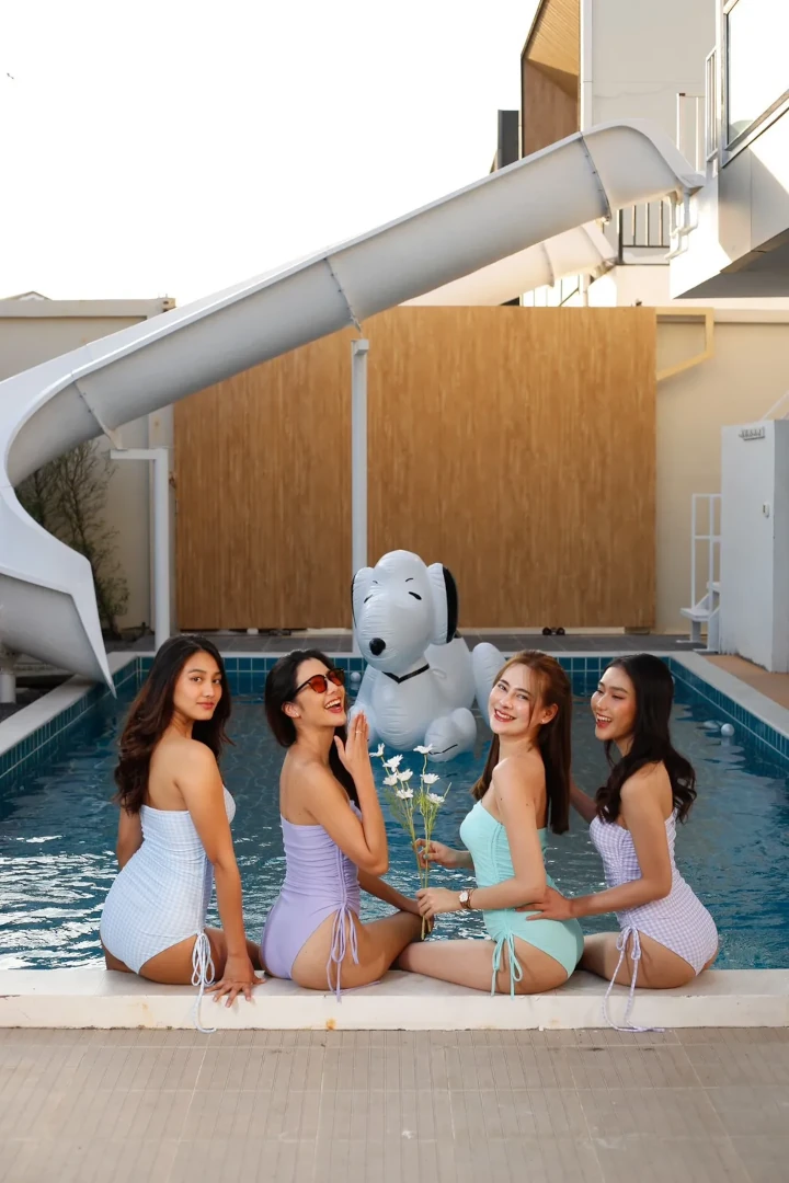 Joyful girls enjoying Songkran festivities at a luxurious pool villa in Pattaya.