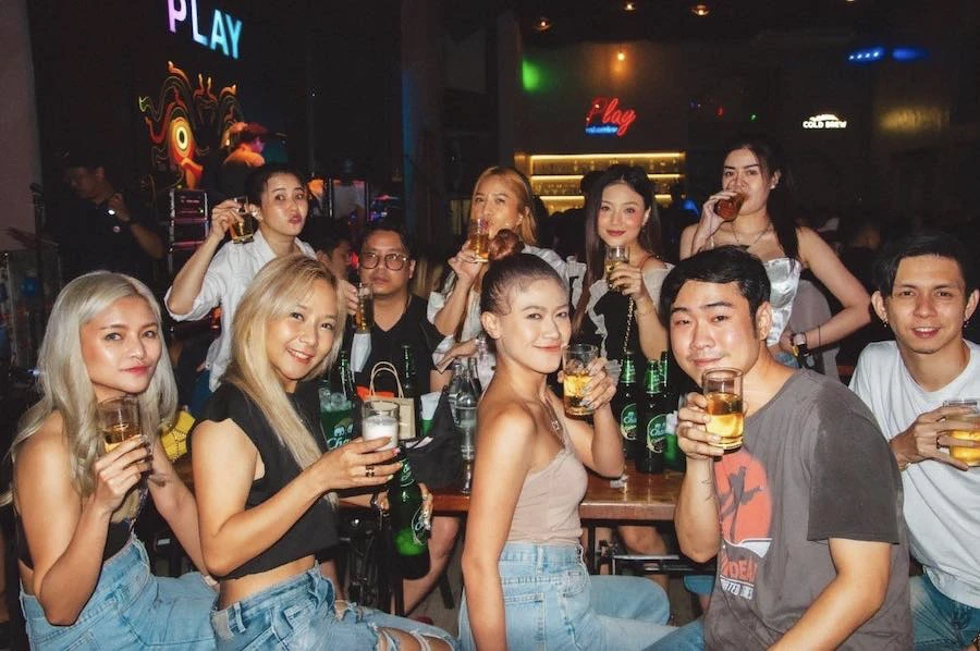 a group of friends posing and drinking at play ratchada