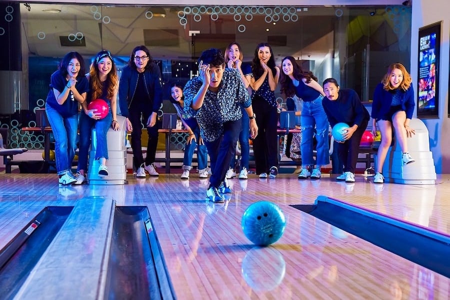 group of friends playing bowling in Bangkok