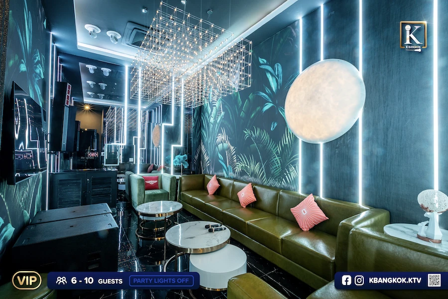 a vip room at k bangkok ktv displaying blue coloured walls and bright lights and a long sofa for people singing