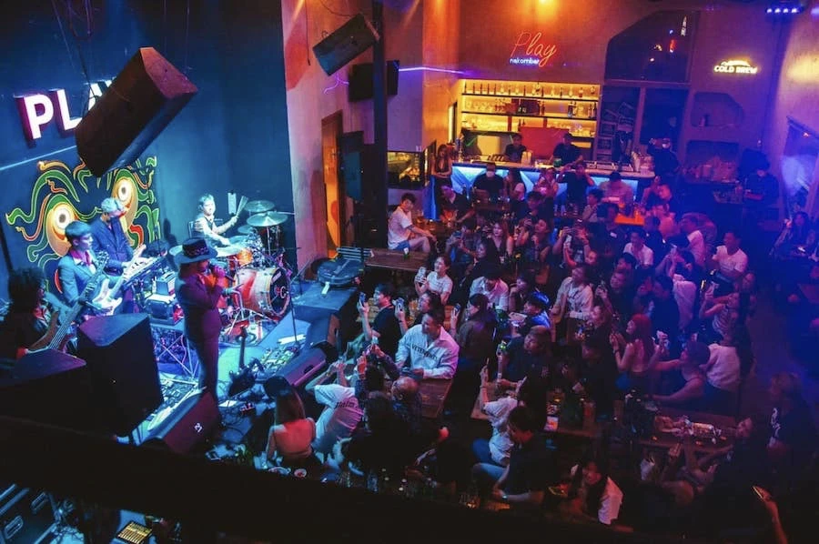 people watching a live music band playing music at play ratchada