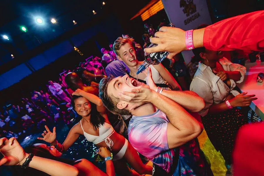 pooring drink into mouth at westin pool party in Bangkok