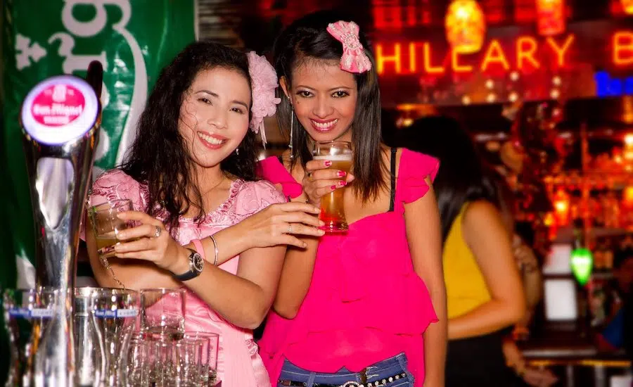 old Thai bar girls drinking at a bar in Bangkok