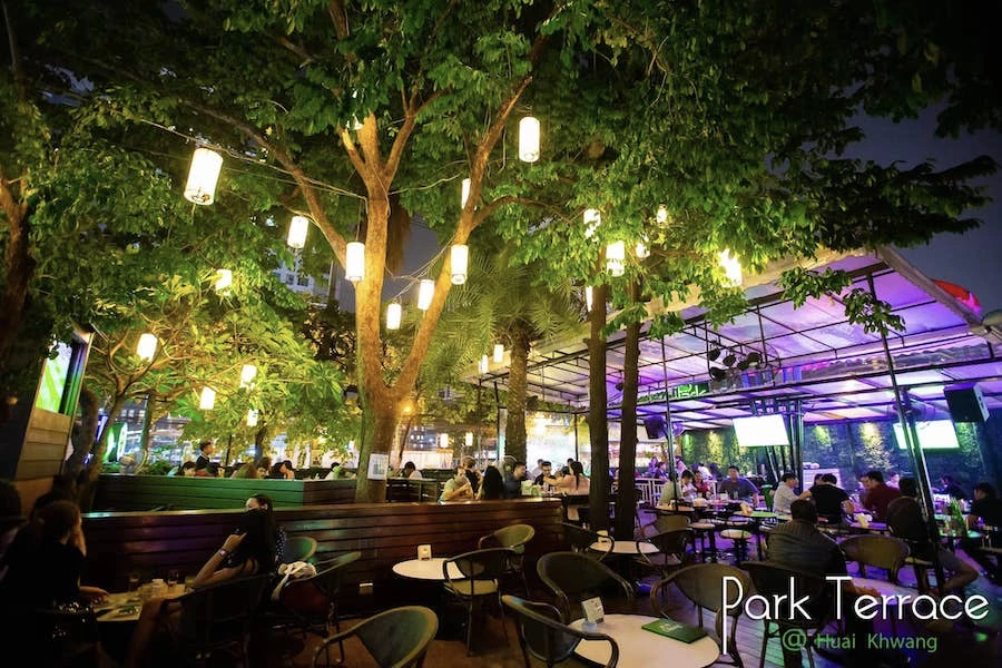 outdoor part of park terrace in bangkok with a tree decorated with lights
