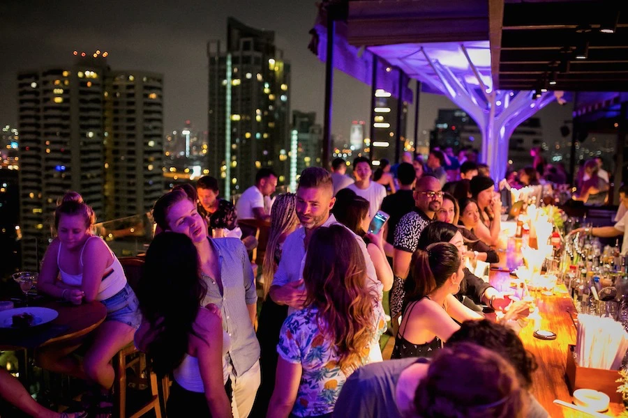 people partying at Above Eleven rooftop bar in Bangkok