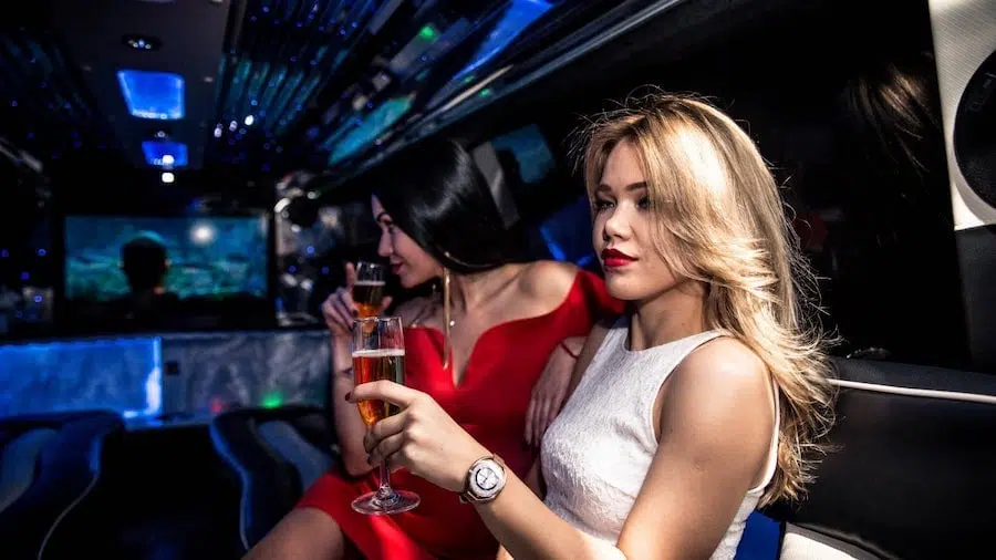 pretty party girls inside a stretch limousine with light system