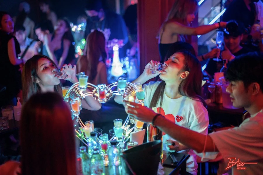 two thai girls drinking colorful shooters in bliss ekkamai