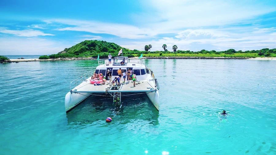 people playing on a yacht during a yacht party around an island in Pattaya Thailand