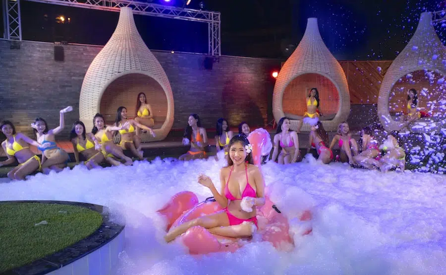 hot Thai bikini models playing with foam at Bangkok top pool club