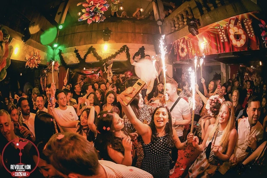 people dancing at revolucion cocktail bar in silom