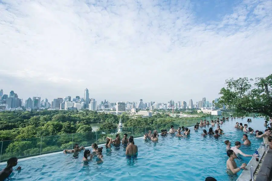 people partying inside the infinity pool of So Sofitel hotel in Bangkok