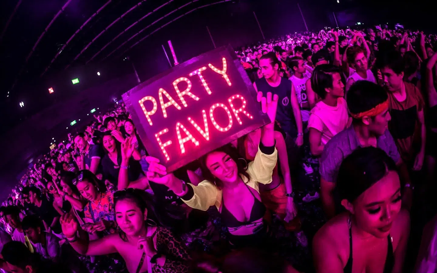 hot Thai girl holding a sign with party favor at a party in Thailand