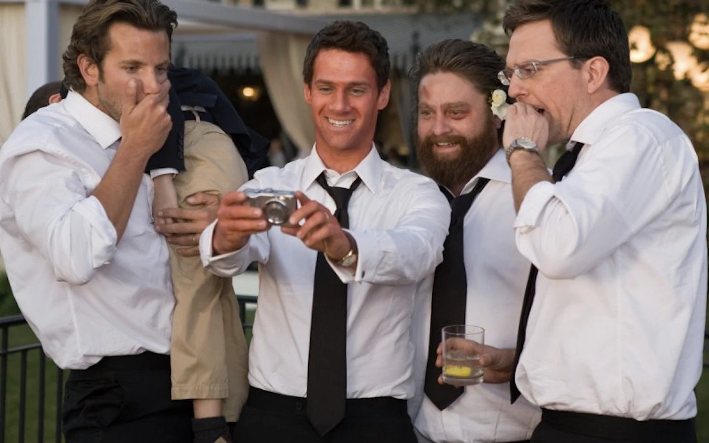 Bachelors watching photos from their bachelor trip in the Hangover 2 movie final scene