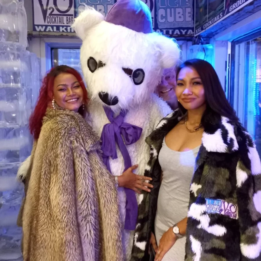 Two girls and a guy with a bear costume smiling at the V Lounge Bar in Pattaya.