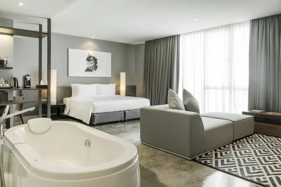 a view of a room at zazz urban bangkok with a central bathtub